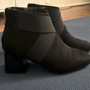 Suede black chunk heel booties with side zip and accent.